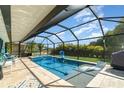 Relax in the screened-in pool area, featuring a spa and ample lounging space at 2248 Bonn Ct, Punta Gorda, FL 33983