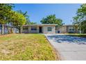 Lovely single-Gathering home featuring a manicured lawn, freshly painted siding, and a concrete driveway at 4621 25Th S Ave, St Petersburg, FL 33711
