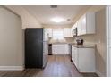 Bright kitchen with white cabinetry, granite countertops, stainless steel appliances, and modern flooring at 4621 25Th S Ave, St Petersburg, FL 33711