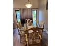 Bright dining room with glass table, decorative centerpiece and views of the backyard at 4666 Clarke St, North Port, FL 34286