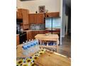 Well-appointed kitchen features stainless steel refrigerator, wooden cabinets and granite countertops at 4666 Clarke St, North Port, FL 34286