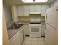 The kitchen features white appliances, cabinets, and countertops at 4826 Marine Pkwy # 202, New Port Richey, FL 34652