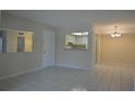 Open living room area with tiled floors that connects to the kitchen at 4826 Marine Pkwy # 202, New Port Richey, FL 34652