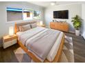 Modern bedroom with luxury vinyl flooring, a ceiling fan, and a large window at 10454 138Th St, Largo, FL 33774