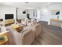 Staged living room with luxury vinyl flooring, stylish furniture, and a light and airy feel at 10454 138Th St, Largo, FL 33774
