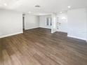 Spacious living room featuring new wood-look floors, neutral paint, and plenty of natural light at 10454 138Th St, Largo, FL 33774