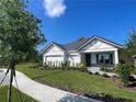 Well-maintained single-story home with lush green lawn, sidewalk, and three-car garage at 2726 Wise River Lane, Zephyrhills, FL 33539
