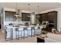 Beautiful kitchen with a large island, stainless steel appliances, and pendant lighting at 2726 Wise River Lane, Zephyrhills, FL 33539