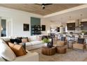 Spacious living room with stylish decor, a wood plank ceiling, and an open floor plan at 2726 Wise River Lane, Zephyrhills, FL 33539