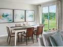 Elegant dining room with modern artwork, natural light, and stylish decor at 233 Lazy Shore Dr, Nokomis, FL 34275