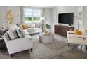 Cozy living room with comfortable seating, large windows, and stylish furnishings at 233 Lazy Shore Dr, Nokomis, FL 34275