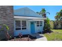 A charming single-story home features blue paint and a bright blue front door, complemented by fresh landscaping at 280 46Th Ave, St Pete Beach, FL 33706