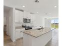 Bright, modern kitchen with granite countertops, stainless steel appliances and an island with sink at 3536 Moscato Dr, Brooksville, FL 34602