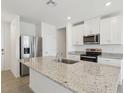 The modern kitchen offers stainless steel appliances, granite counters, and ample cabinet space at 3536 Moscato Dr, Brooksville, FL 34602