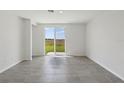 Bright living room with tile floors and sliding glass doors leading to the backyard at 3536 Moscato Dr, Brooksville, FL 34602