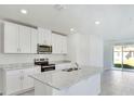 Modern kitchen boasts a center island, stainless steel appliances, and granite countertops at 437 Lazy Shore Dr, Nokomis, FL 34275