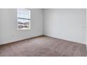 Cozy bedroom featuring neutral carpet and a window with natural light at 10008 Last Light Gln, Parrish, FL 34219