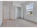Comfortable bedroom with carpet, closet, and natural light streaming through the window at 10008 Last Light Gln, Parrish, FL 34219