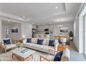 Bright living room features neutral decor and seamlessly connects to the open-concept kitchen and dining area at 10008 Last Light Gln, Parrish, FL 34219