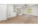 Bright living room with a large window and a glass sliding door to the backyard at 2174 Brubeck Rd, North Port, FL 34287