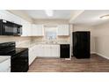 Updated kitchen featuring white cabinets, granite countertops, and new appliances at 626 Belleview Blvd, Clearwater, FL 33756