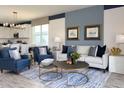 Comfortable living room with stylish furnishings, open floor plan, and decoratively painted accent wall at 9548 Vibrant Lane, Venice, FL 34292