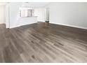 Bright, open living room with luxury vinyl flooring and open floor plan into the kitchen at 22162 Weeks Blvd, Land O Lakes, FL 34639