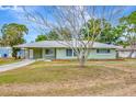Inviting single-story home with a well-maintained lawn and mature tree in the front yard at 5208 30Th W St, Bradenton, FL 34207