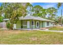 Charming single-story home featuring a covered porch, well-manicured lawn, and classic architectural details at 5208 30Th W St, Bradenton, FL 34207