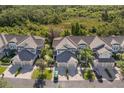 Aerial view showcases the property's roof, driveway, and lush green surroundings at 8035 St Simons St # 8035, University Park, FL 34201