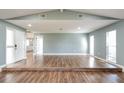 Expansive living room featuring vaulted ceilings and wood flooring providing lots of space at 10237 Bannock St, Spring Hill, FL 34608