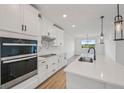 Bright kitchen boasting modern appliances, white cabinetry and quartz countertops at 13839 Richland Gulf Cir, Parrish, FL 34219
