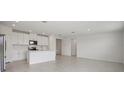 Modern kitchen featuring white cabinetry, stainless steel appliances, and a functional island at 7736 Gilchrist Springs Dr, Parrish, FL 34219