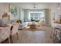 Inviting living room features a large sofa, stylish decor, and natural light, perfect for relaxation and entertaining at 17378 Alderwood Ln, Punta Gorda, FL 33982