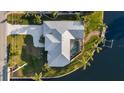 Waterfront home features private pool, dock, and lush landscaping at 9277 St Paul Dr, Port Charlotte, FL 33981