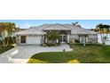 Charming waterfront home with metal roof, lush landscaping, and canal views at 9277 St Paul Dr, Port Charlotte, FL 33981