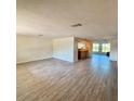 Spacious living room with hard surface flooring and an open floor plan overlooking the kitchen at 5428 Nutmeg Ave, Sarasota, FL 34231