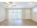 Bright living room with new flooring, large windows, and a ceiling fan at 1314 Larsen Ln, Tampa, FL 33619