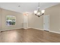 Bright living room with hardwood floors, large windows, and neutral wall paint at 12219 Hunters Lake Dr, New Port Richey, FL 34654