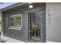 Detailed view of the front door showcasing stone accents and modern house numbers at 1807 49Th W Ave, Bradenton, FL 34207