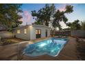 Backyard features an in-ground swimming pool with a white pool house and fenced yard at 1820 Marvy Ave, Tampa, FL 33612