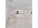 Spacious kitchen with white cabinets, granite countertops, and stainless steel appliances at 3504 Kearsney Abbey Cir, Dover, FL 33527