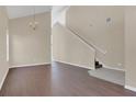 Inviting entryway with hardwood floors, staircase and a chandelier, leading to the upper level at 4432 Huddlestone Dr, Wesley Chapel, FL 33545