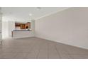 Spacious open-concept living space with neutral tile and a view into the kitchen area at 4722 67Th N Ave, Pinellas Park, FL 33781