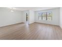 Bright living room with laminate floors, large windows and a door leading to a balcony at 11901 4Th N St # 2107, St Petersburg, FL 33716