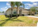 Inviting home showcasing a lush lawn, two-car garage, and well-maintained landscaping at 13188 Royal Pines Ave, Riverview, FL 33579