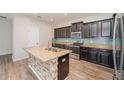 Stylish kitchen featuring stainless steel appliances, granite countertops, and a center island at 13188 Royal Pines Ave, Riverview, FL 33579