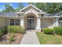Elegant double front doors with decorative glass and a welcoming walkway at 621 Erin Way, Brooksville, FL 34601