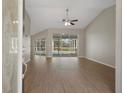 Bright living room with hardwood floors and sliding glass doors to the pool area at 621 Erin Way, Brooksville, FL 34601