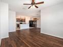 Open-concept living room with tile floors, seamlessly connecting to the kitchen and dining areas for modern living at 2587 Garden Plum Pl, Odessa, FL 33556